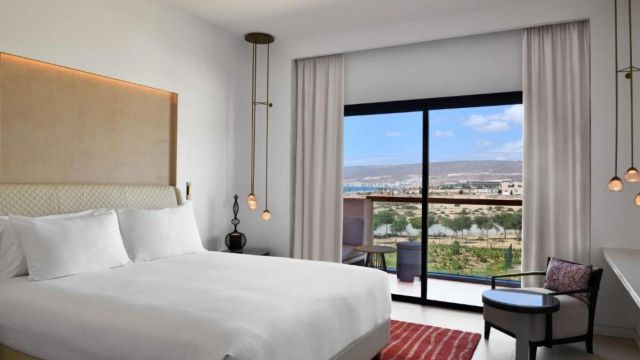 Guest Room with Two Double Beds and Partial Sea View